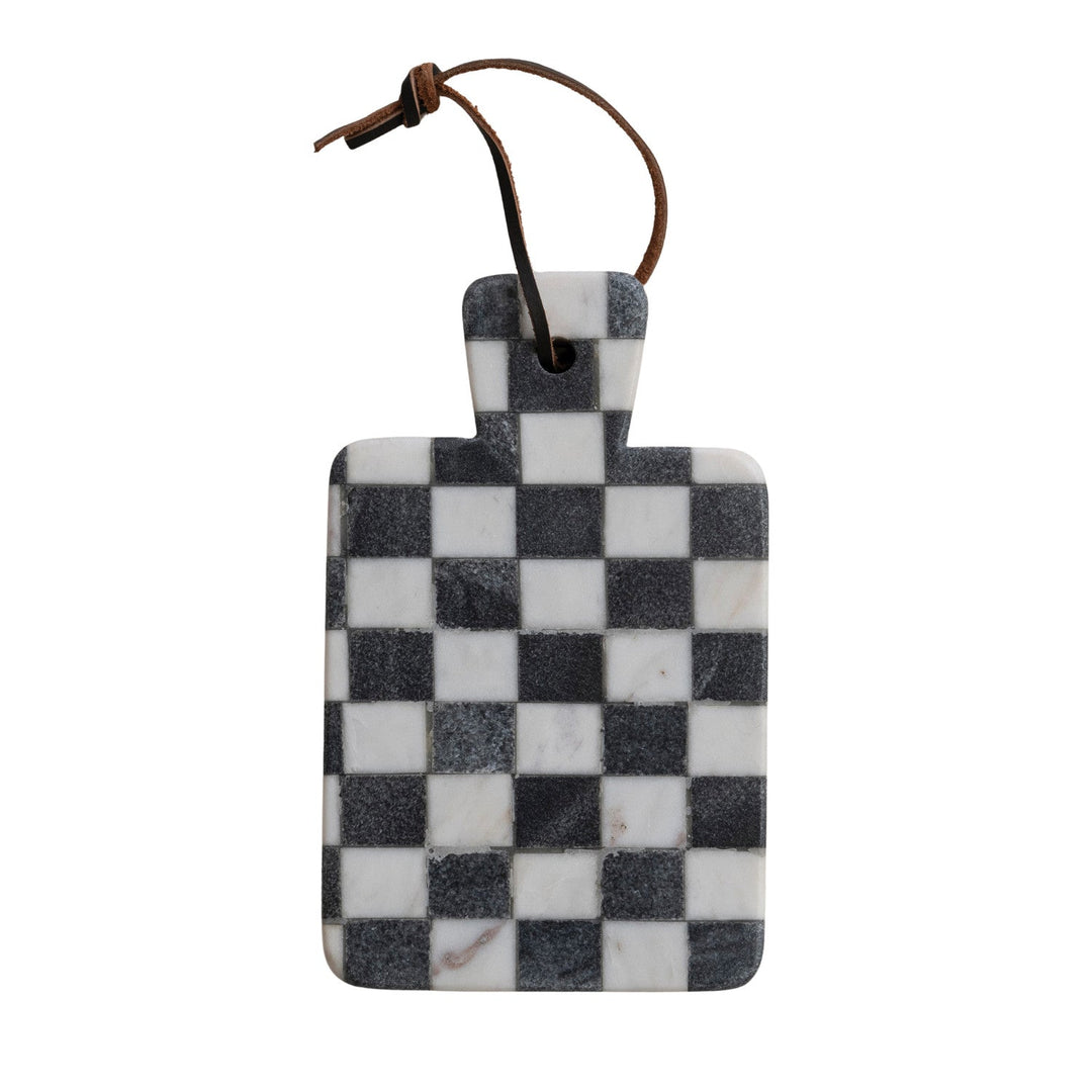 Black and white check marble cheese board hanging by its faux leather tie