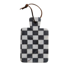 Black and white check marble cheese board hanging by its faux leather tie