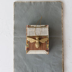 Resin Bee Ornament with Wire Legs, Gold Finish, 2-3/4"H shown on its gift card - seasonal decor by Creative Co-Op - Whats New Furniture Portland OR