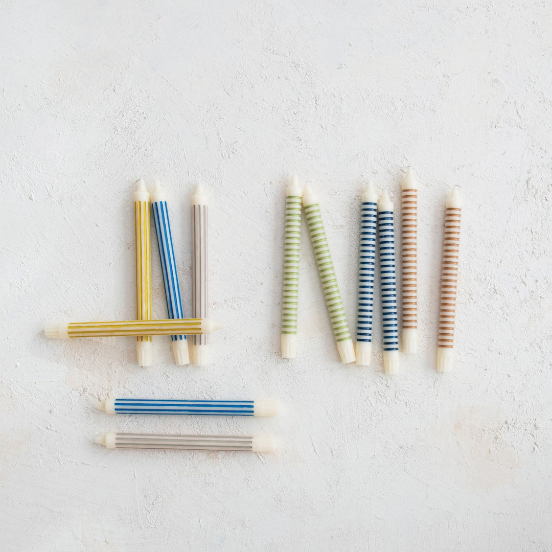Striped taper candles shown in the range of available colors