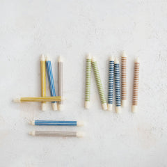 Striped taper candles shown in the range of available colors