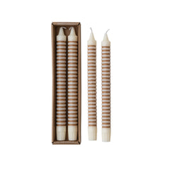 Tan striped taper candles in their box beside the pair of candles