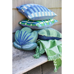Outdoor throw with fan pattern styled in a stack of patio pillows with a palm leaf pillow on a garden bench - Whats New Furniture Portland OR