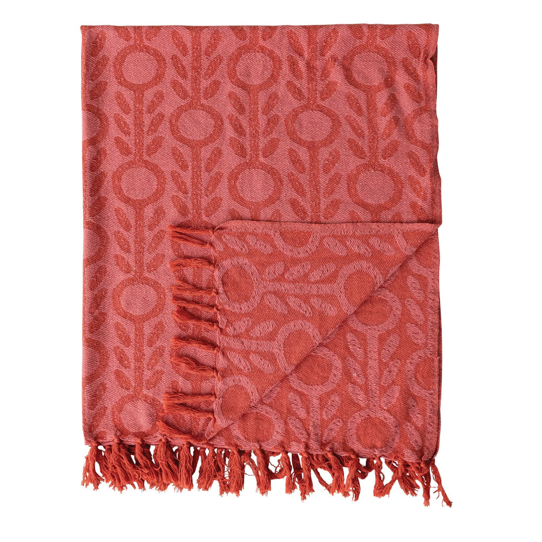Folded corner of the recycled cotton jacquard throw showing the woven floral pattern and knotted fringe - Whats New Furniture Portland