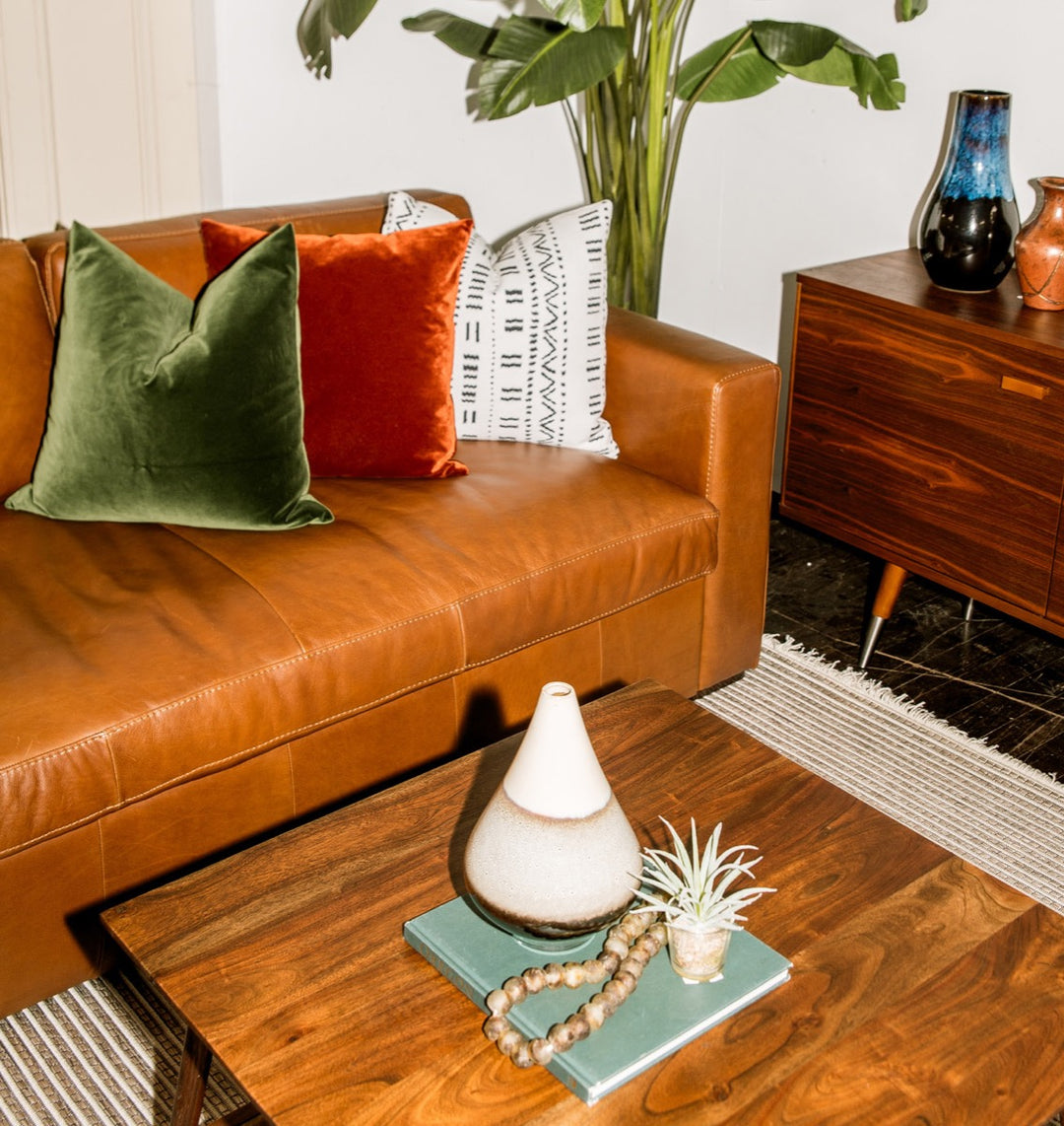 Custom leather sofa with accent pillows and walnut coffee table at Whats New Furniture Portland