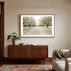 Entrance to Eden glass framed orchard photography styled above a walnut sideboard in a Portland living room - Whats New Furniture