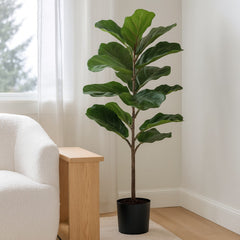 Faux fiddle leaf fig tree styled beside a boucle chair in a Portland living room - Whats New Furniture
