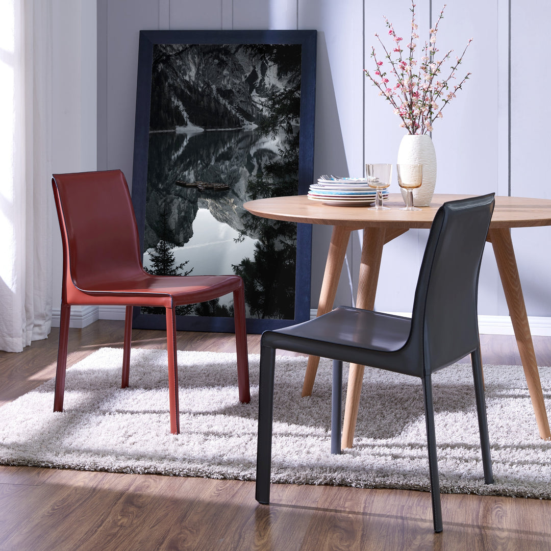 Gervin Chair Anthracite at a round wood dining table - shown beside the cordovan colorway