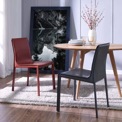 Gervin Chair Anthracite at a round wood dining table - shown beside the cordovan colorway