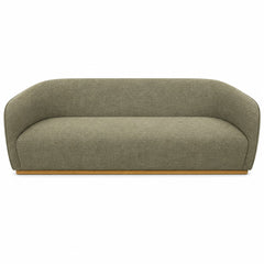 Green mid-century sofa with warm oak trim and clean horizontal lines