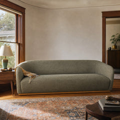 Green mid-century sofa with warm oak trim and clean horizontal lines - view 2