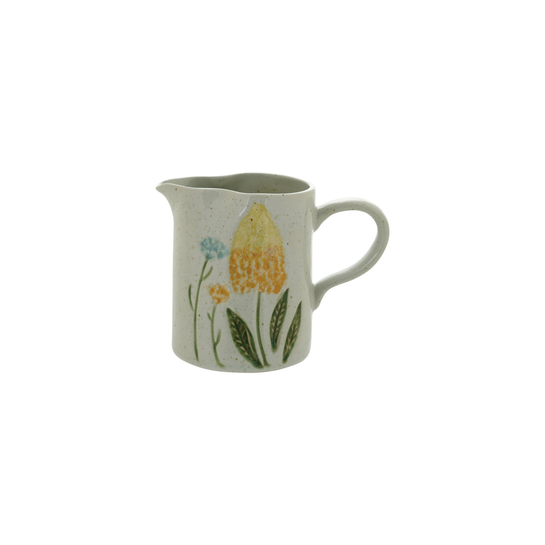 Hand-painted stoneware creamer with a yellow tulip and blue wildflowers