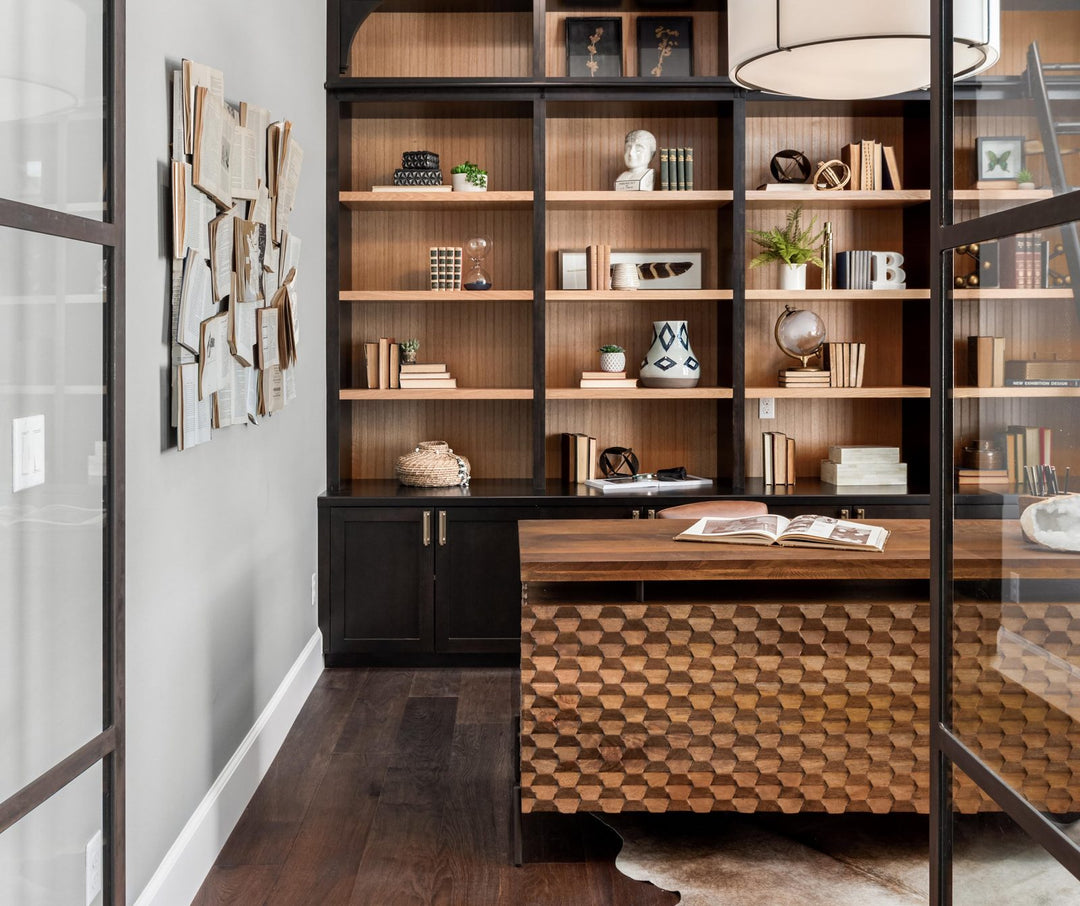 Home office interior design by Whats New Furniture in Portland Oregon - carved wood desk with built-in black bookshelves and glass doors