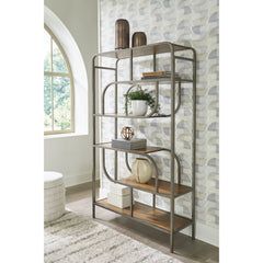 Jaddon Bookcase in brown lifestyle setting - 5-shelf sculptural metal bookcase by Ashley - Whats New Furniture Portland OR