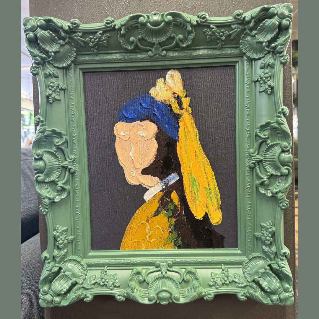 Framed acrylic portrait painting in a carved green baroque frame, photographed in the What's New Furniture showroom