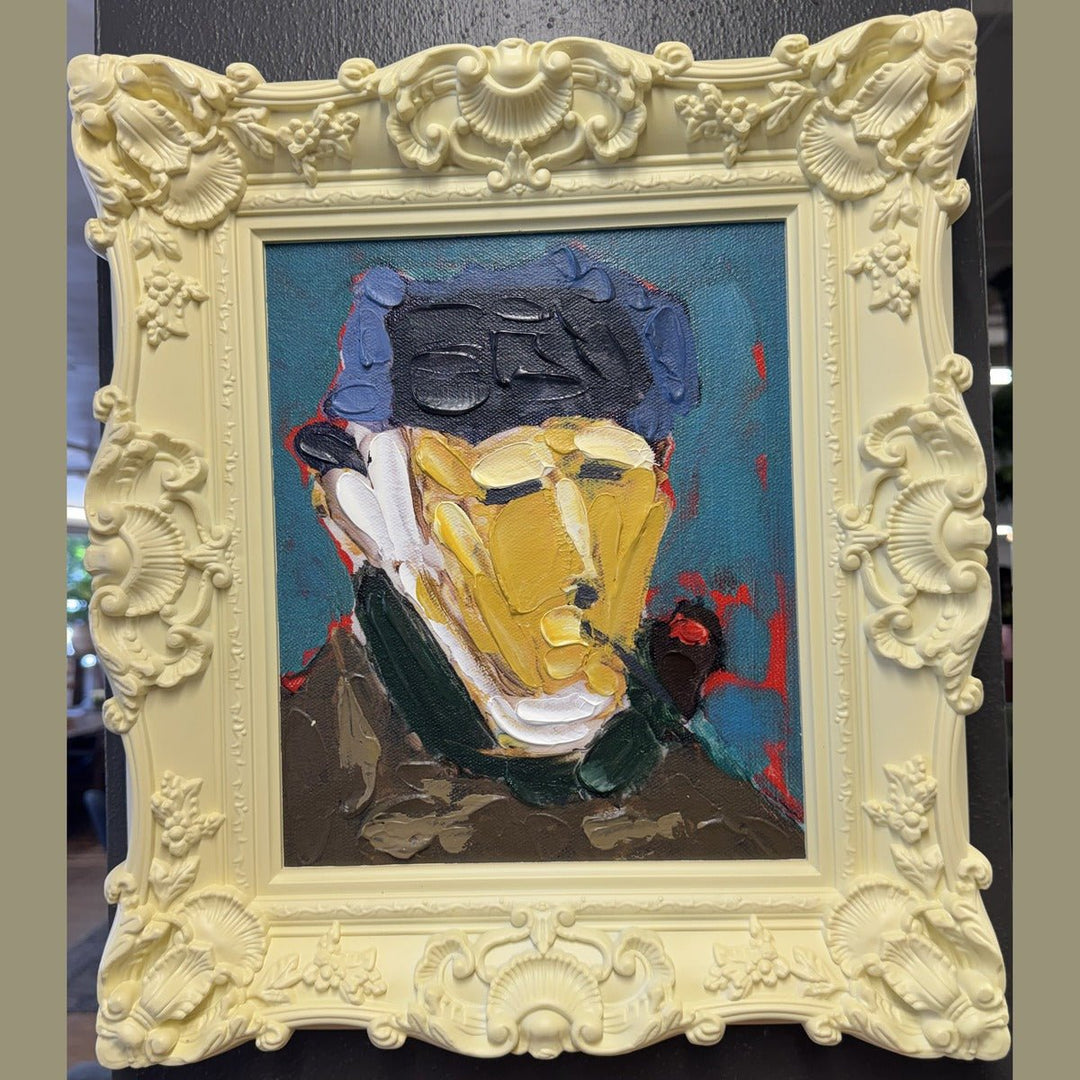 Framed acrylic portrait painting in a carved pale yellow baroque frame, photographed in the What's New Furniture showroom
