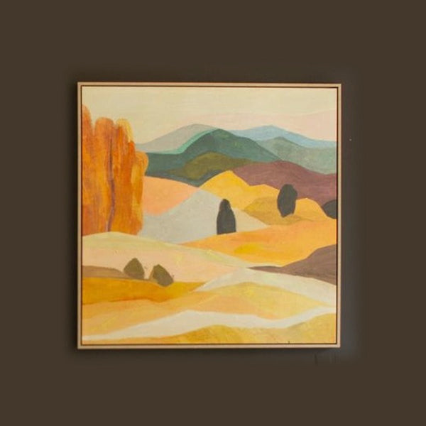 Framed desert landscape painting with an orange bluff in a light wood floater frame