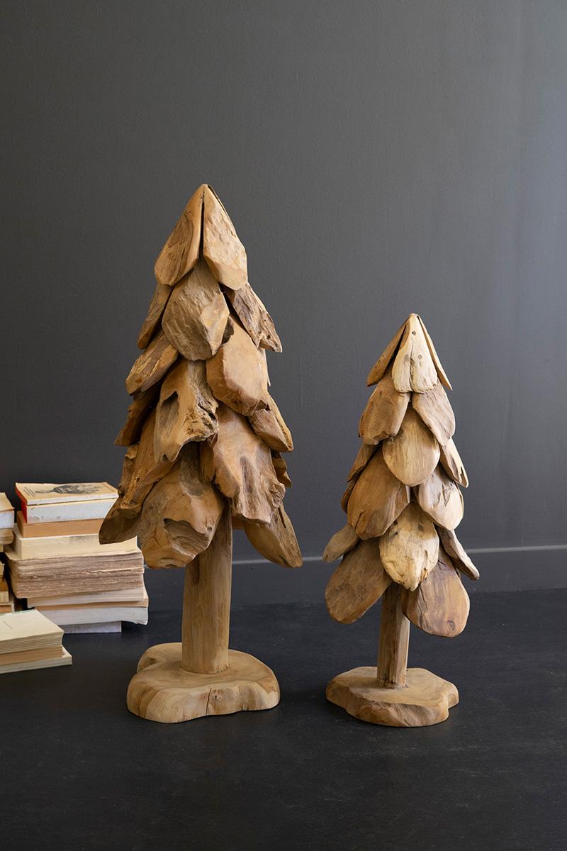 Large and small rustic teak Christmas trees shown together against a dark grey wall - carved wood holiday decor by Kalalou - Whats New Furniture Portland OR