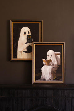 Both framed ghost paintings leaned on a dark sideboard, one hung and one propped - ghost wall art by Kalalou - Whats New Furniture Portland OR