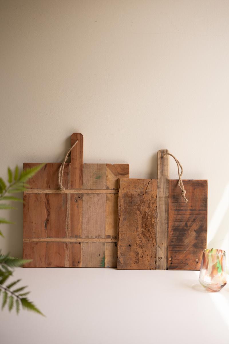Set of 2 Recycled Wood Cheese Boards leaning on a counter beside a fern and a painted glass - reclaimed wood decor by Kalalou - Whats New Furniture Portland OR