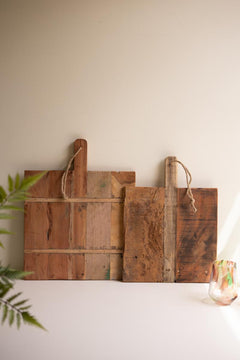 Set of 2 Recycled Wood Cheese Boards leaning on a counter beside a fern and a painted glass - reclaimed wood decor by Kalalou - Whats New Furniture Portland OR
