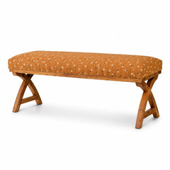 Kalalou upholstered bench with warm patterned fabric and crossed wooden supports on a white studio background.