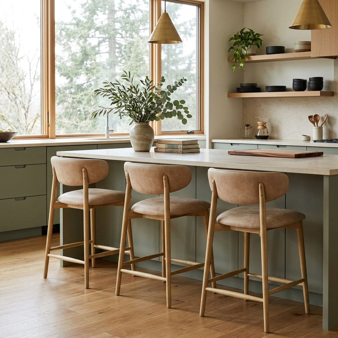 Milo Counter Stool in Natural top-grain leather styled at a kitchen island in a Portland Northwest-modern kitchen with sage cabinets and Douglas fir view — What&