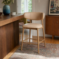 Milo Counter Stool in Nude, upholstered counter stool at a kitchen island in a Portland home - Whats New Furniture