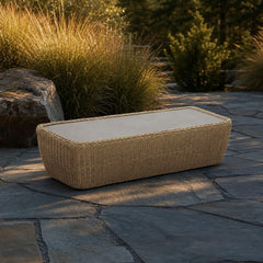 Siesta Outdoor Coffee Table on a bluestone patio with ornamental grasses and warm late-afternoon light - What&