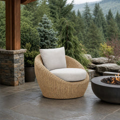 Siesta Outdoor Round Club Chair on a covered outdoor veranda with a low fire table nearby - What&