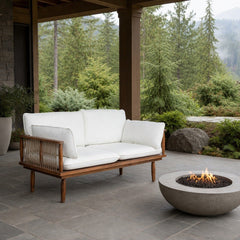 Vineyard Outdoor Loveseat on a covered outdoor veranda with a low fire table nearby - What&