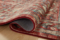 Rolled corner of the Eve Crimson Courtyard rug showing pile and woven backing - Whats New Furniture Portland OR
