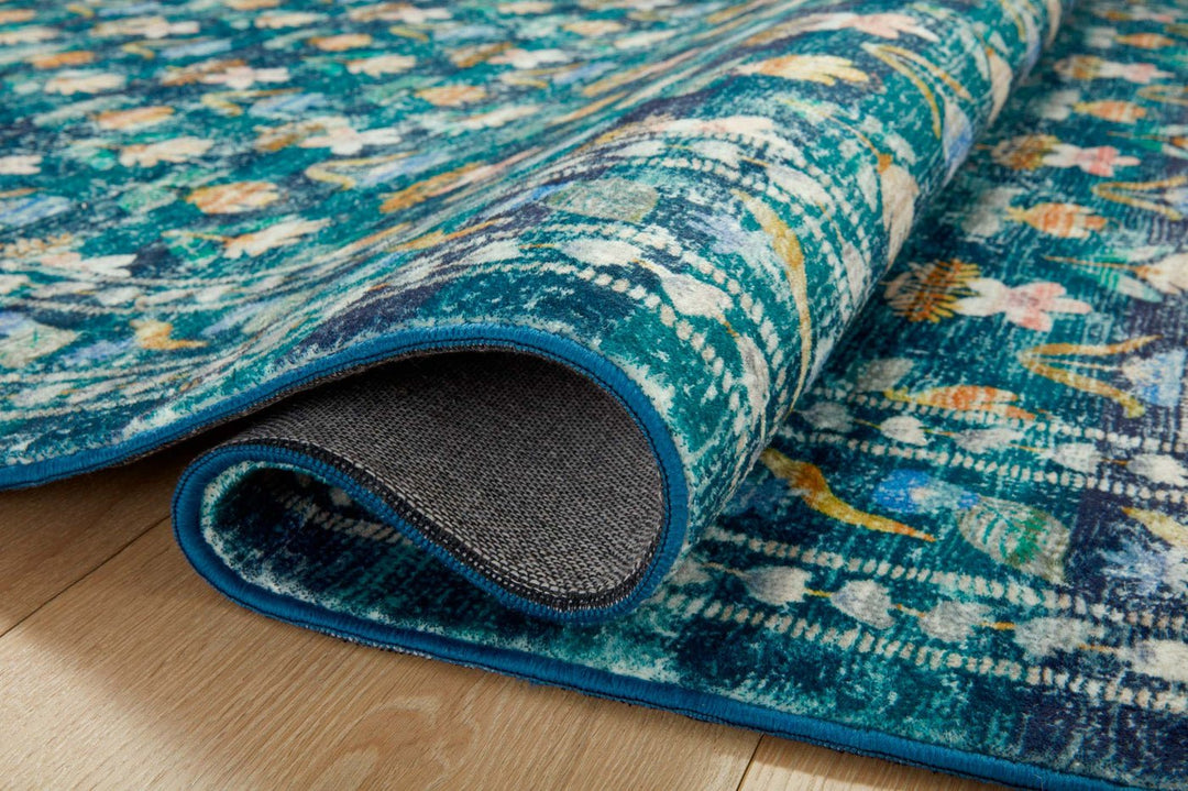 Rolled corner of the Hadley Emerald Courtyard rug showing pile depth and backing - Whats New Furniture Portland OR