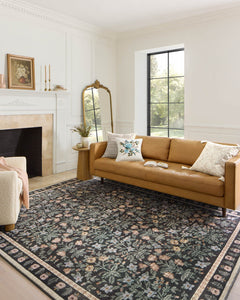 Mughal Garden Black Eden rug styled in a bright living room with a camel leather sofa - Whats New Furniture