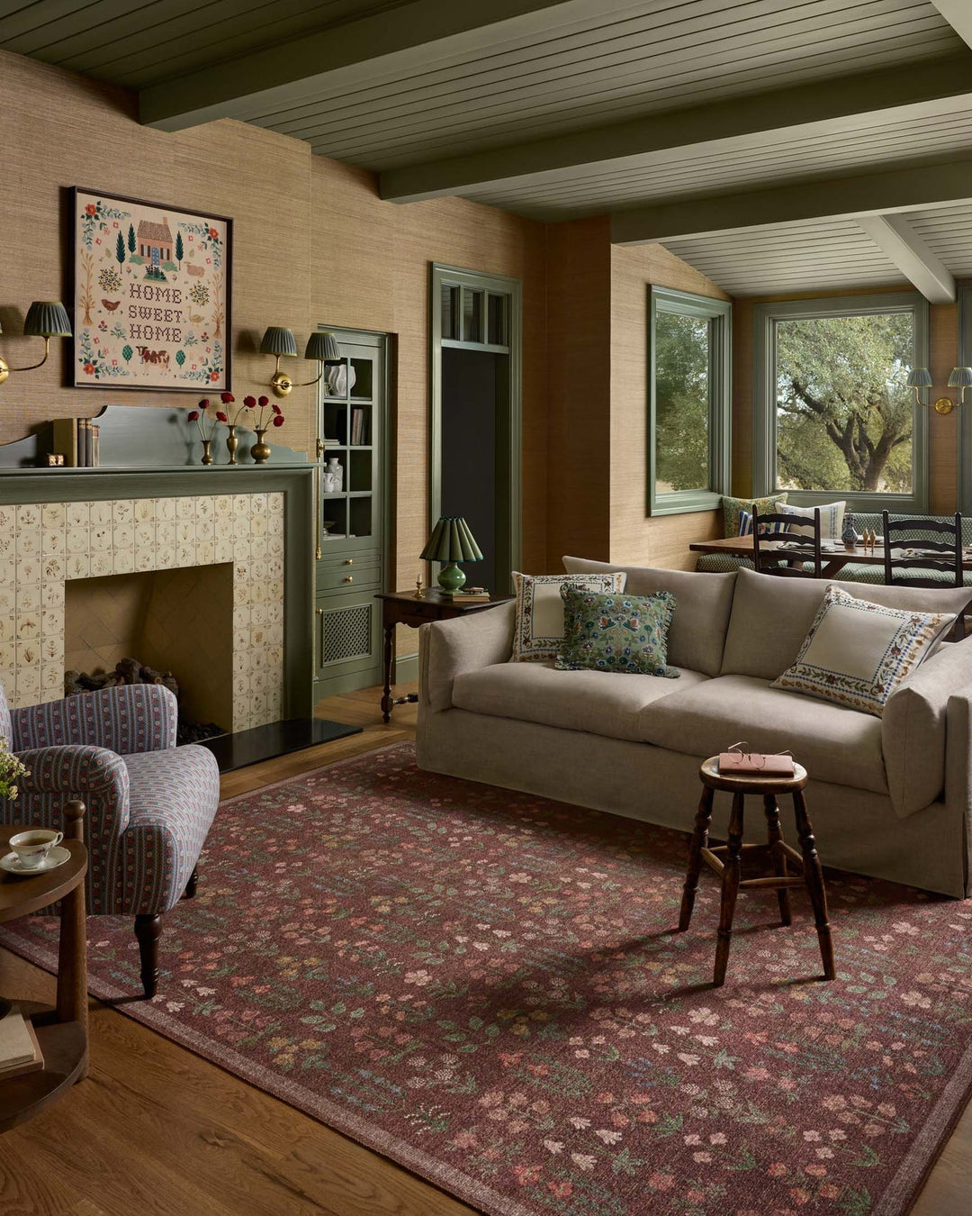 Merlot Edinburgh jute rug styled in a wood-paneled den with green built-ins - Rifle Paper Co. x Loloi - Whats New Furniture