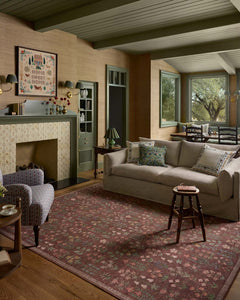 Merlot Edinburgh jute rug styled in a wood-paneled den with green built-ins - Rifle Paper Co. x Loloi - Whats New Furniture
