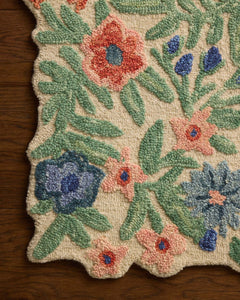 Close-up of the hand-tufted peach and blue blooms on the Edith Ivory Multi accent rug - Whats New Furniture Portland OR