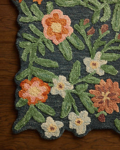 Close-up of the hand-tufted orange and cream blooms on the Edith Navy Multi accent rug - Whats New Furniture Portland OR