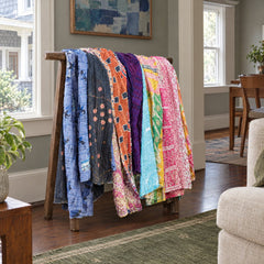Assorted multicolor Kantha throws styled on a rack; sold individually, rack excluded - Whats New Furniture Portland OR