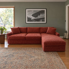 Rust chaise sectional with an extended chaise lounge end. - detail view 1