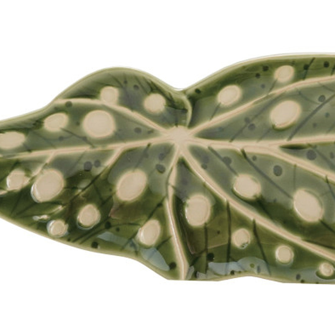 Close-up of the raised cream wax-relief spots and leaf veining on the green stoneware plate - Creative Co-Op - Whats New Furniture Portland OR