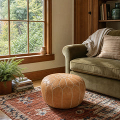 Tan round pouf ottoman with a low cylindrical silhouette. - detail view 1