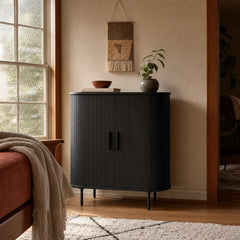 Nola Cabinet in Black Oak beside a window in a warm living room - Whats New Furniture