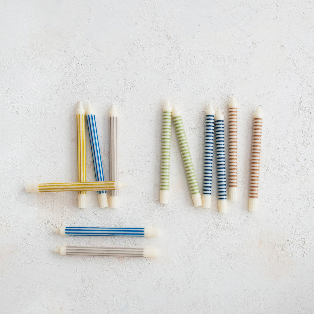Striped taper candles shown in the range of available colors