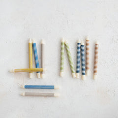 Striped taper candles shown in the range of available colors