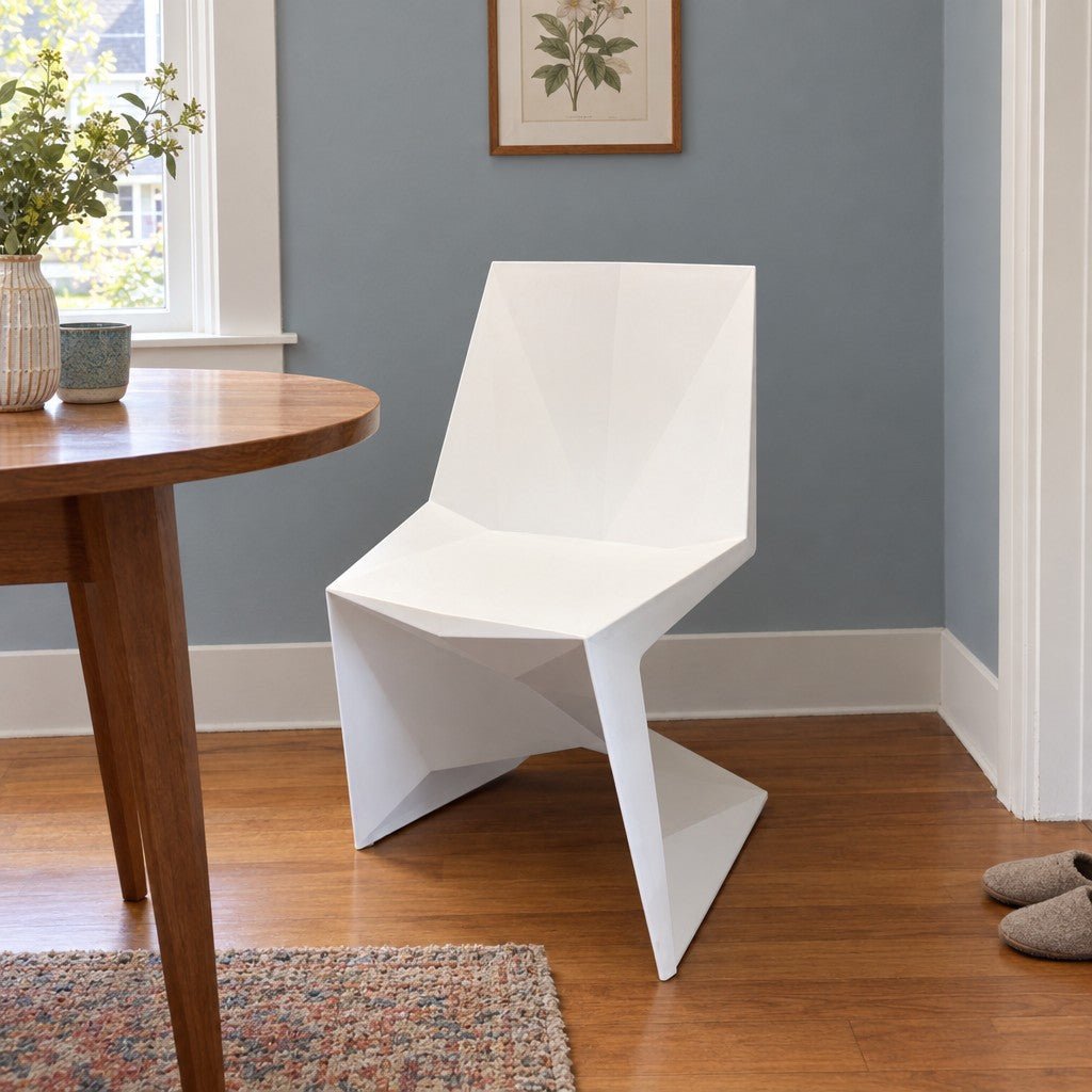 White geometric dining chair with an angular molded shell by VONDOM - detail view 1