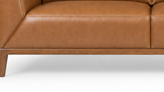 Close-up of the solid wood plinth base and tapered leg on the Oro leather sofa - What’s New Furniture Portland