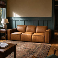 Solado Top-Grain Leather Sofa in Camel against blue-green paneling in a living room - Whats New Furniture