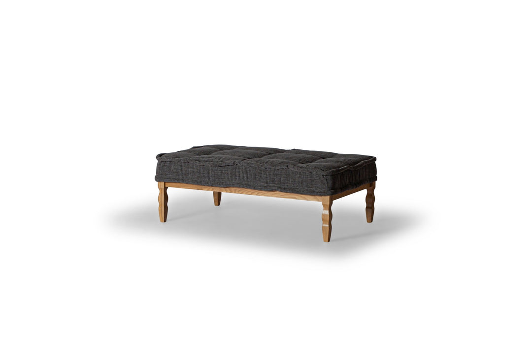 Lewis Fabric-Top Coffee Table in anthracite tufted top on wood frame — front three-quarter angle — What&