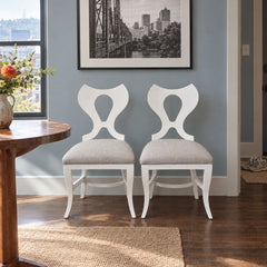 White dining chairs sold as a matching set of two with clean contemporary lines. - detail view 1